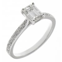 Kiss style Emerald cut diamond solitaire engagement ring with grain set diamond shoulders