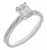 Kiss style Emerald cut diamond solitaire engagement ring with grain set diamond shoulders