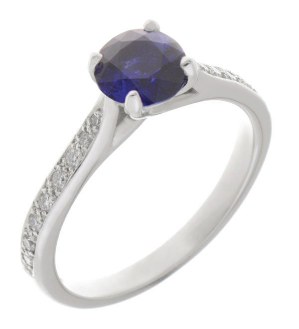 Kiss style round blue sapphire solitaire ring with grain set diamond shoulders