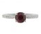 Kiss style round ruby solitaire ring with grain set diamond shoulders top view
