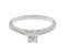 Kiss style oval diamond solitaire engagement ring with grain set diamond shoulders angle view