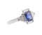 Art deco emerald cut blue sapphire and baguette diamond cluster ring angle view