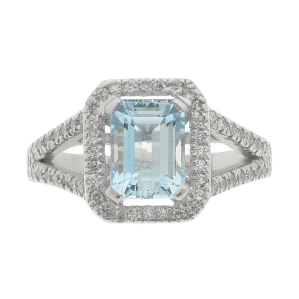 Classic emerald cut aqua and diamond halo cluster ring with split diamond set shoulders top