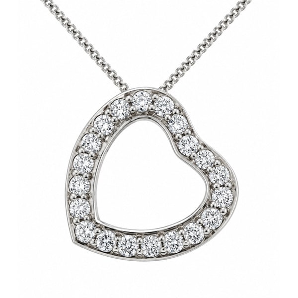 A heart shaped pendant with grain set round brilliant cut diamonds. designed to sit at an angle designer modern pendant gold platinum