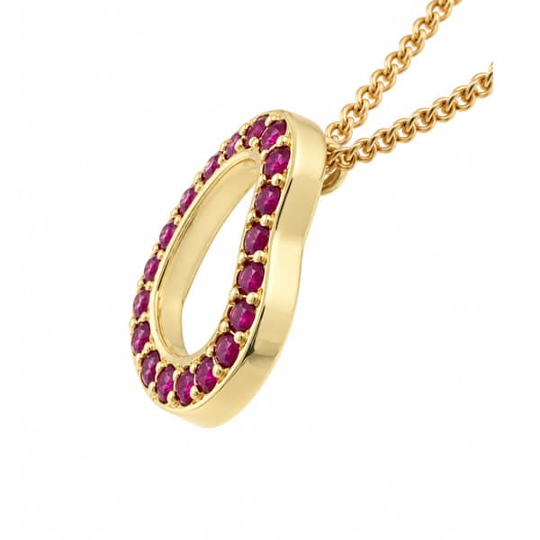 A heart shaped pendant with grain set round ruby rubies. designed to sit at an angle designer modern pendant gold platinum chain