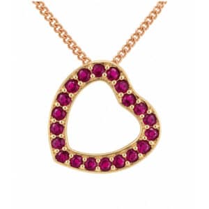 A heart shaped pendant with grain set round ruby rubies. designed to sit at an angle designer modern pendant gold platinum chain
