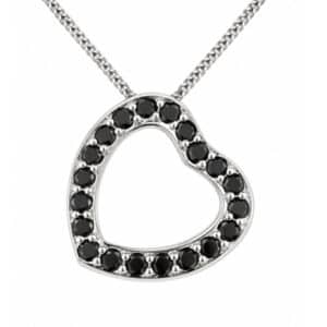 A heart shaped pendant with grain set round black diamonds. designed to sit at an angle designer modern pendant gold platinum