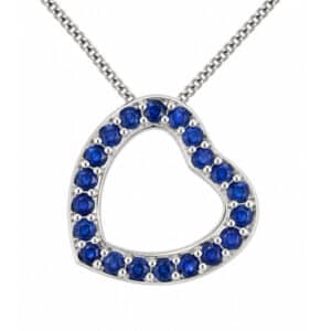 A heart shaped pendant with grain set round blue sapphires. designed to sit at an angle designer modern pendant gold platinum chain