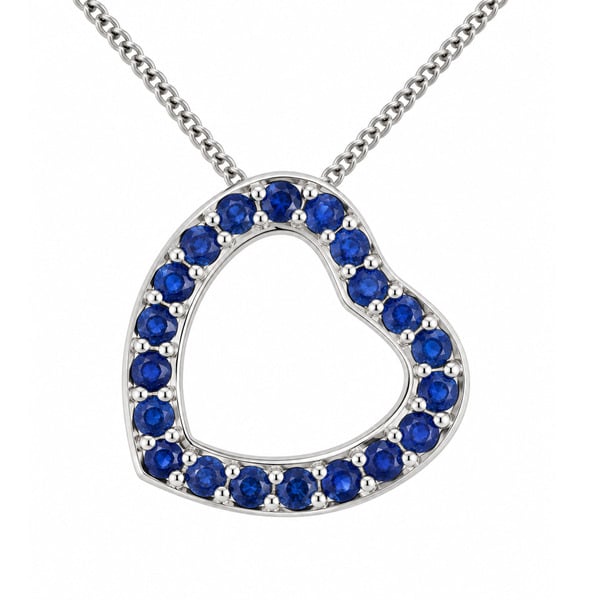 A heart shaped pendant with grain set round blue sapphires. designed to sit at an angle designer modern pendant gold platinum chain