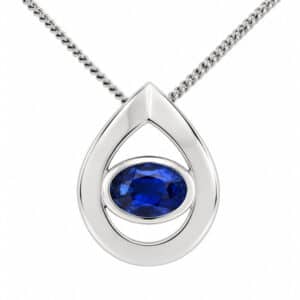 A modernist pear shape tear drop pendant with an oval blue sapphire centre stone in rubover setting. designer modern gold platinum chain