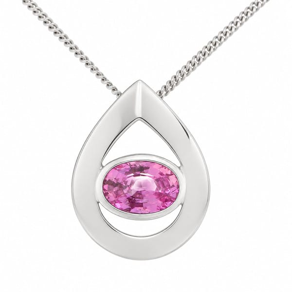 A modernist pear shape tear drop pendant with an oval pink sapphire centre stone in rubover setting designer modern gold platinum chain
