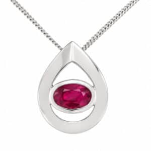 A modernist pear shape tear drop pendant with an oval Ruby centre stone in rubover setting. designer modern gold platinum chain