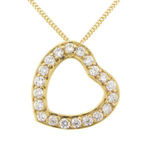 A heart shaped pendant with grain set round brilliant cut diamonds. designed to sit at an angle designer modern pendant gold platinum
