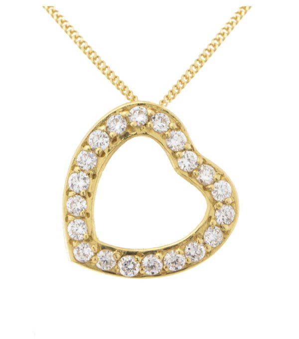 A heart shaped pendant with grain set round brilliant cut diamonds. designed to sit at an angle designer modern pendant gold platinum