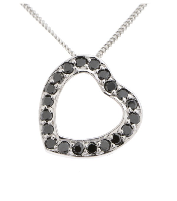 A heart shaped pendant with grain set round black diamonds. designed to sit at an angle designer modern pendant gold platinum