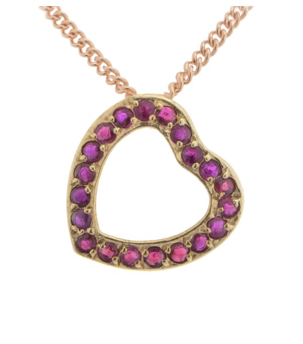 A heart shaped pendant with grain set round ruby rubies. designed to sit at an angle designer modern pendant gold platinum chain