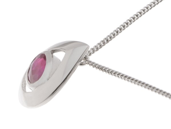 A modernist pear shape tear drop pendant with an oval Ruby centre stone in rubover setting. designer modern gold platinum chain