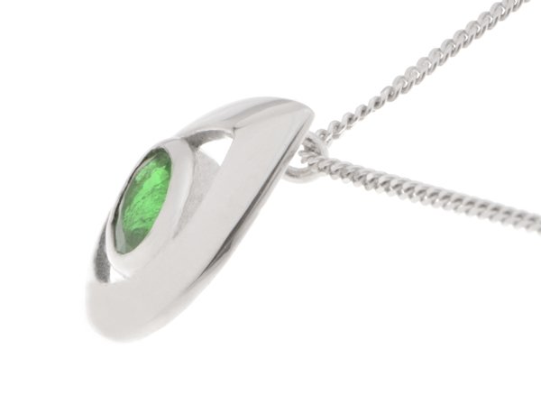 A modernist pear shape tear drop pendant with an oval emerald centre stone in rubover setting. designer modern gold platinum chain