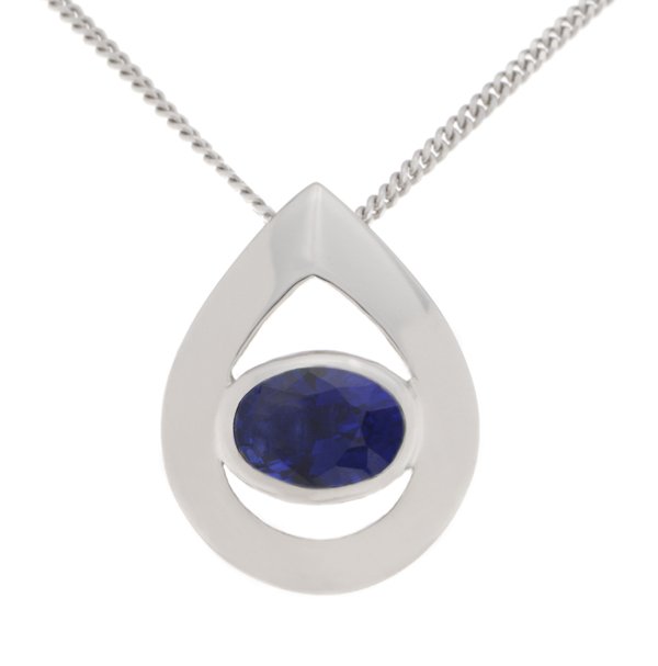 A modernist pear shape tear drop pendant with an oval blue sapphire centre stone in rubover setting. designer modern gold platinum chain
