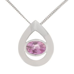 A modernist pear shape tear drop pendant with an oval pink sapphire centre stone in rubover setting. designer modern gold platinum chain