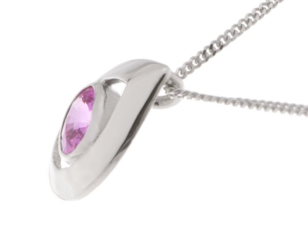 A modernist pear shape tear drop pendant with an oval pink sapphire centre stone in rubover setting. designer modern gold platinum chain