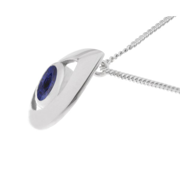 A modernist pear shape tear drop pendant with an oval blue sapphire centre stone in rubover setting. designer modern gold platinum chain