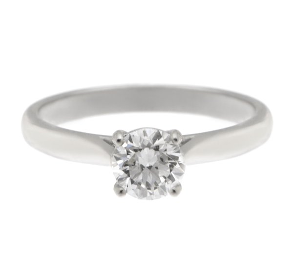 An elegant round brilliant cut diamond solitaire engagement ring kiss style crossover setting platinum gold