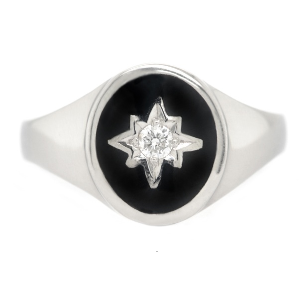 An Art deco style oval signet ring black enamel star set round brilliant cut diamond