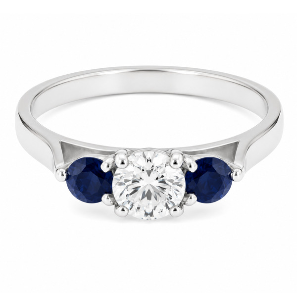modern classic round brilliant cut diamond trilogy ring with round blue sapphire accent side stones platinum gold three claw set