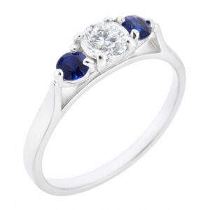 modern classic round brilliant cut diamond trilogy ring with round blue sapphire accent side stones platinum gold three claw set