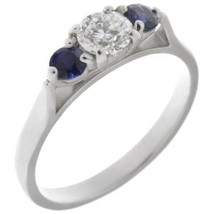 modern classic round brilliant cut diamond trilogy ring with round blue sapphire accent side stones platinum gold three claw set