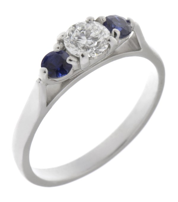 modern classic round brilliant cut diamond trilogy ring with round blue sapphire accent side stones platinum gold three claw set