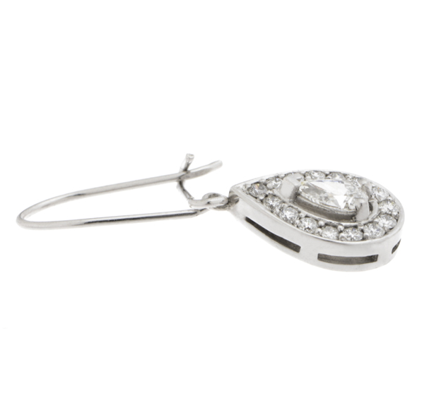 Classic art deco style drop earrings with a pear shape main diamond and a halo of round brilliant cut diamonds platinum gold