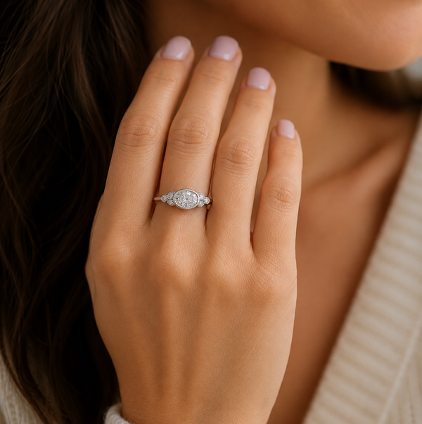 Classic art deco style ring oval shape cut diamond centre stone millgrain round diamonds shoulders vintage engagement platinum gold