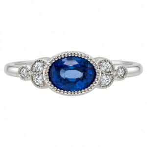 Classic art deco vintage style ring oval shape blue sapphire round diamond millgrain engagement cluster platinum gold