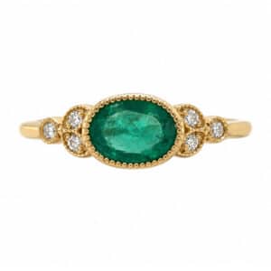 Classic art deco vintage style ring oval shape green emerald round diamond millgrain engagement cluster platinum gold
