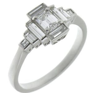 Classic art deco style modern ring emerald cut diamond centre stone stepped baguette cut diamonds cluster setting platinum gold