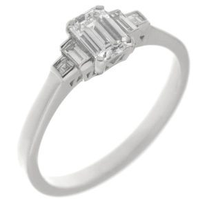 Classic art deco style modern ring emerald cut diamond centre stone stepped graduated baguette cut diamonds shoulders setting platinum gold