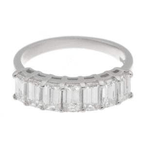 1920's art deco style seven stone Emerald step cut Diamond eternity ring with claw settings Platinum Gold