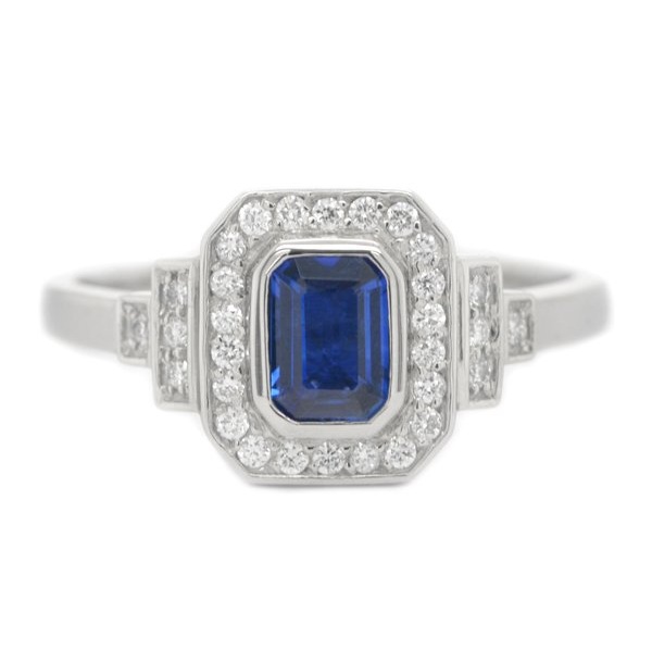 Classic 1920's art deco style emerald cut Blue Sapphire halo ring round brilliant cut diamonds surround stepped shoulders platinum gold