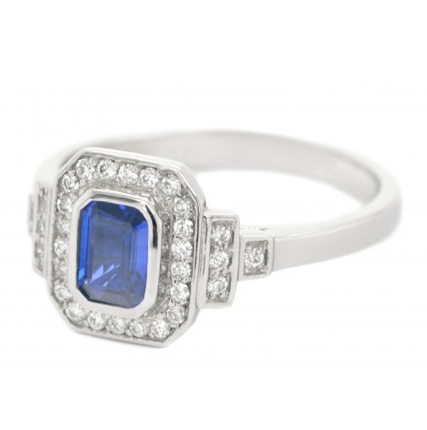 Classic 1920's art deco style emerald cut Blue Sapphire halo ring round brilliant cut diamonds surround stepped shoulders platinum gold