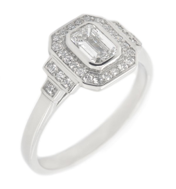 Classic 1920's art deco style emerald cut Diamond halo ring round brilliant cut diamonds surround stepped shoulders platinum gold