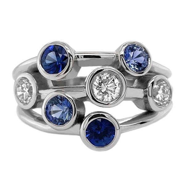 Modern contemporary scatter style cluster ring rubbed over round blue sapphires round brilliant cut diamonds platinum gold