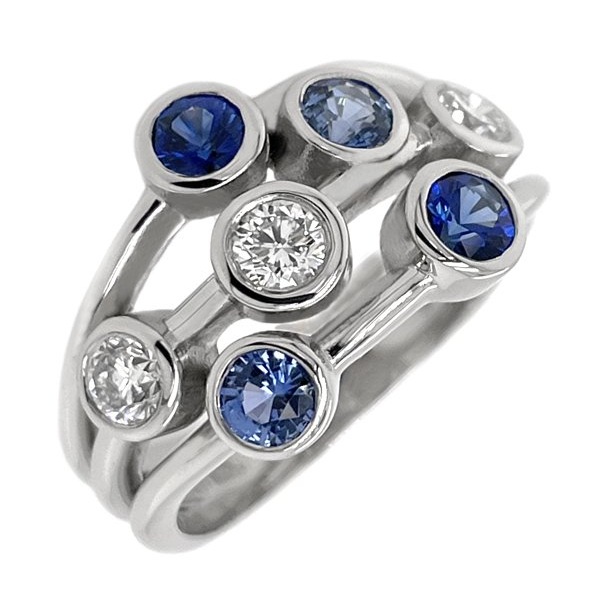 Modern contemporary scatter style cluster ring rubbed over round blue sapphires round brilliant cut diamonds platinum gold