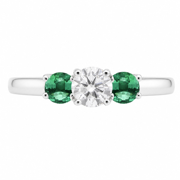 classic trilogy style ring round diamond centre stone & two green emerald side stones claw set setting gold platinum