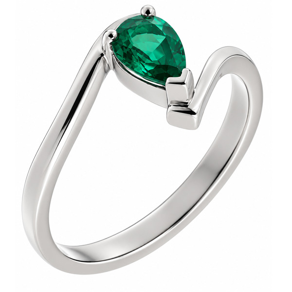 A modern crossover, wrap around style ring with a claw set solitaire pear cut shape green emerald contemporary design designer platinum gold