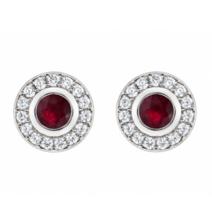 Classic cluster style earrings with a rubover set central round ruby rubies with a halo of grain set round brilliant cut diamonds platinum gold
